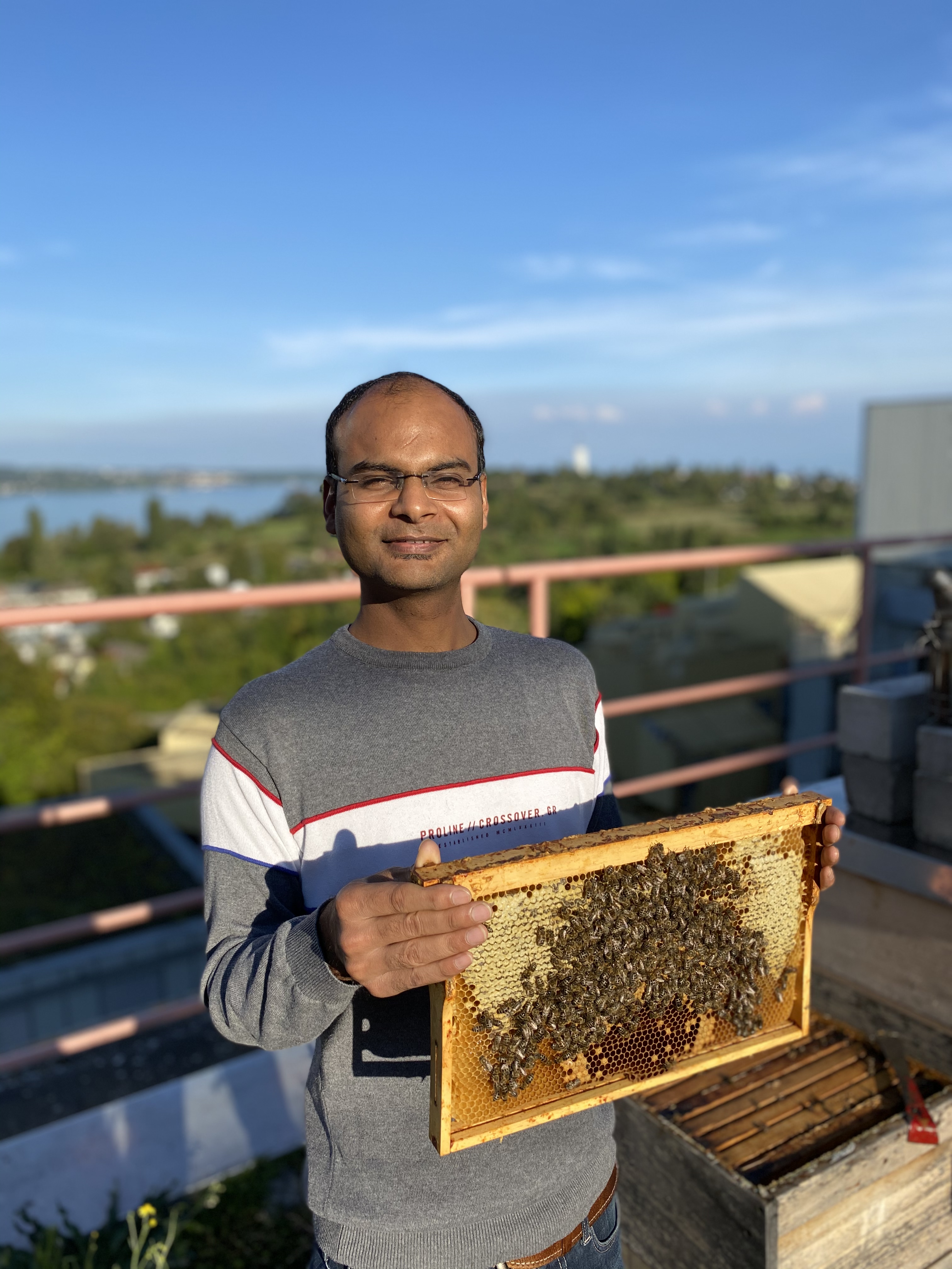Jitesh holding honey bee frame
